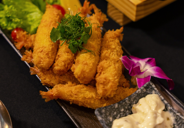 Crispy fried shrimp tempura served with dipping sauce and fresh garnish as part of a corporate event catering spread at ibis Singapore on Bencoolen