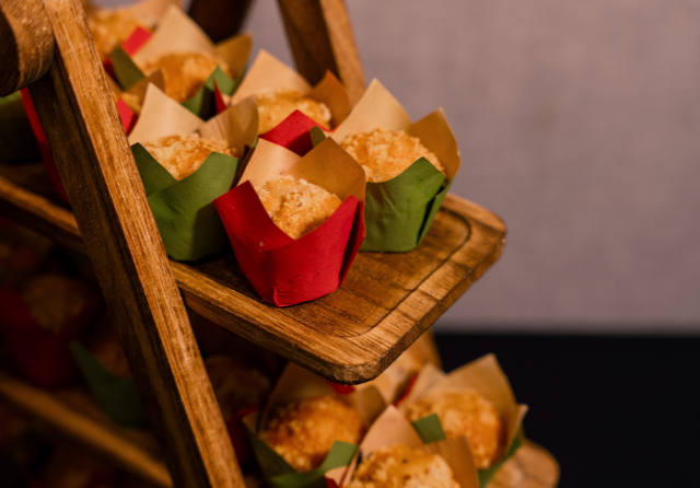 Assorted mini muffins displayed on a rustic wooden stand during a meeting coffee break at ibis Singapore on Bencoolen