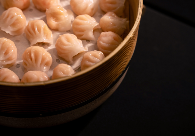 Steamed dim sum selection served in a bamboo basket as part of a corporate catering setup at ibis Singapore on Bencoolen