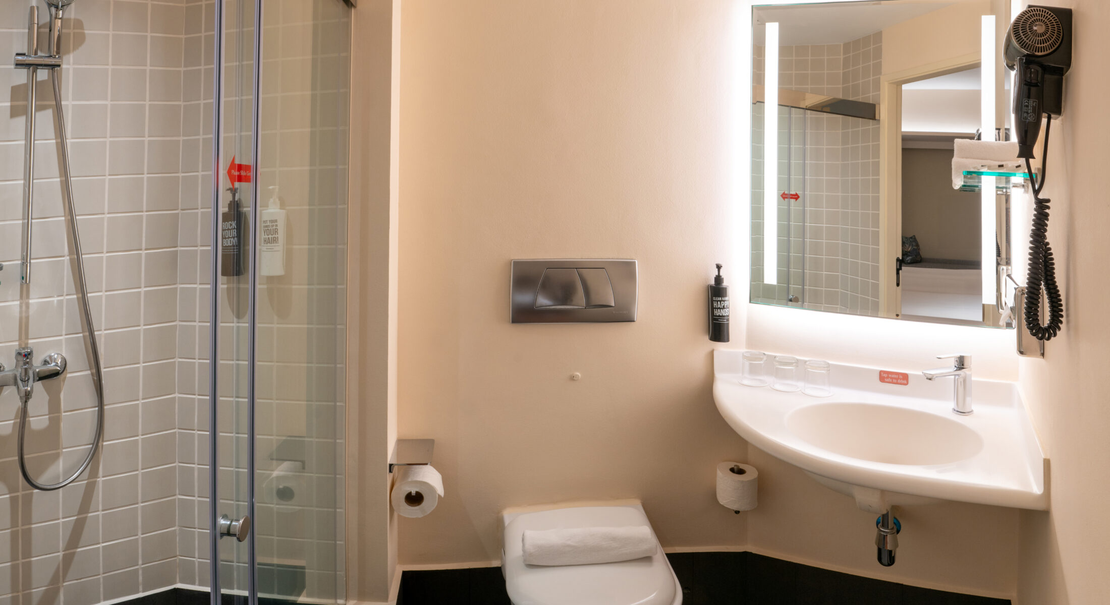 Bathroom with complimentary amenities including a toothbrush, comb, and cotton buds.