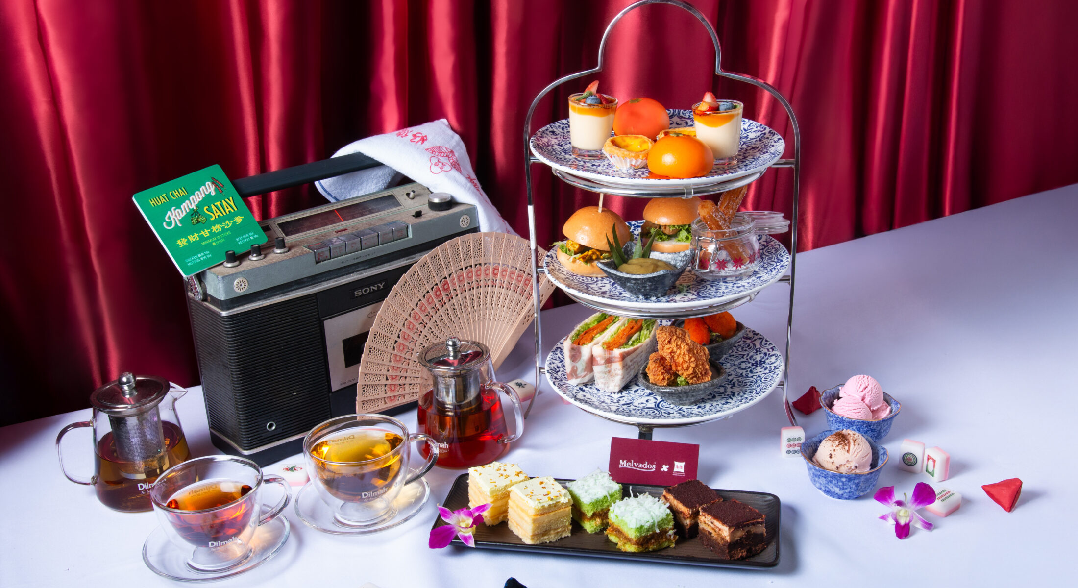 Three-tier SG60 High Tea stand with local and fusion delights, Melvados cakes and ice cream, served with premium teas, styled with vintage props at ibis Singapore on Bencoolen’s Taste Restaurant.