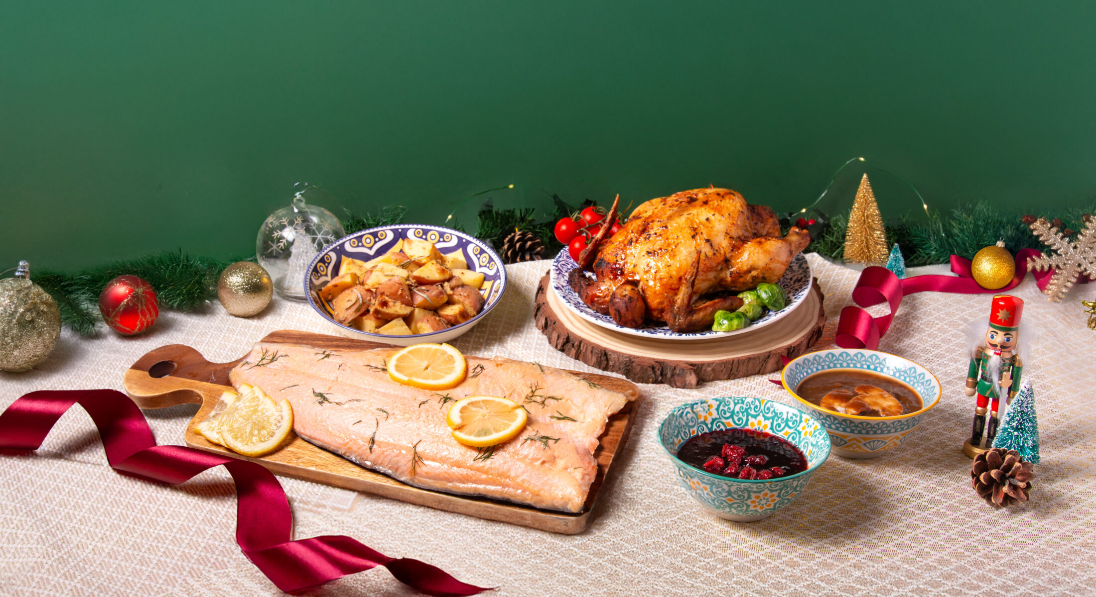 Festive platter of Crimson-Spiced Roast Chicken Supreme and Miso Clout Trout with golden potatoes and Christmas décor from TASTE Restaurant, ibis Singapore on Bencoolen.