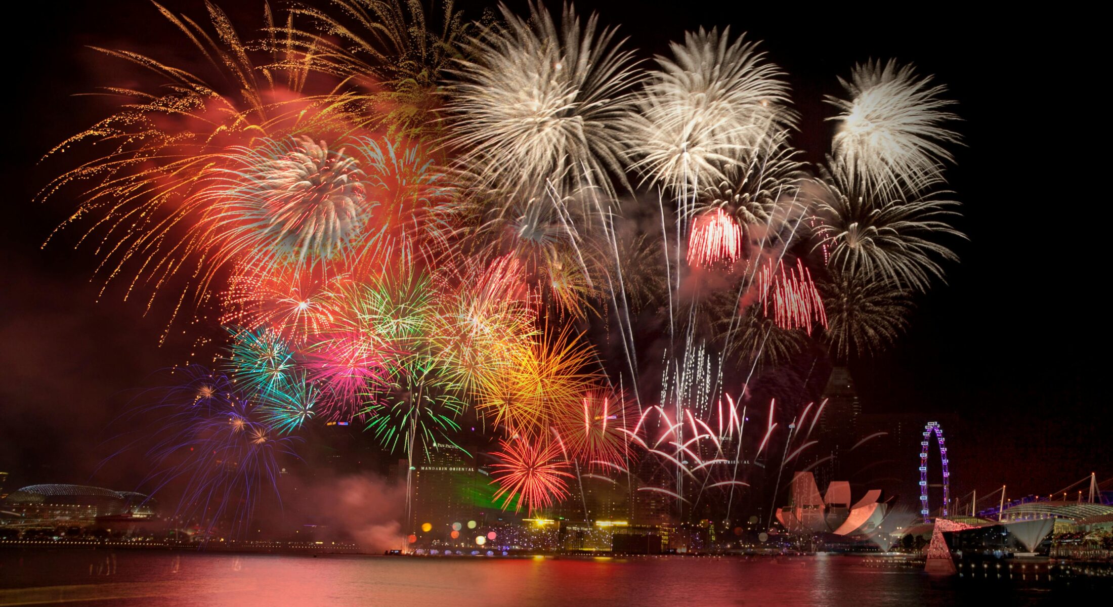 Fireworks lighting up the Singapore skyline over Marina Bay during a major city celebration, showcasing live events, concerts and festivals near ibis Singapore on Bencoolen.