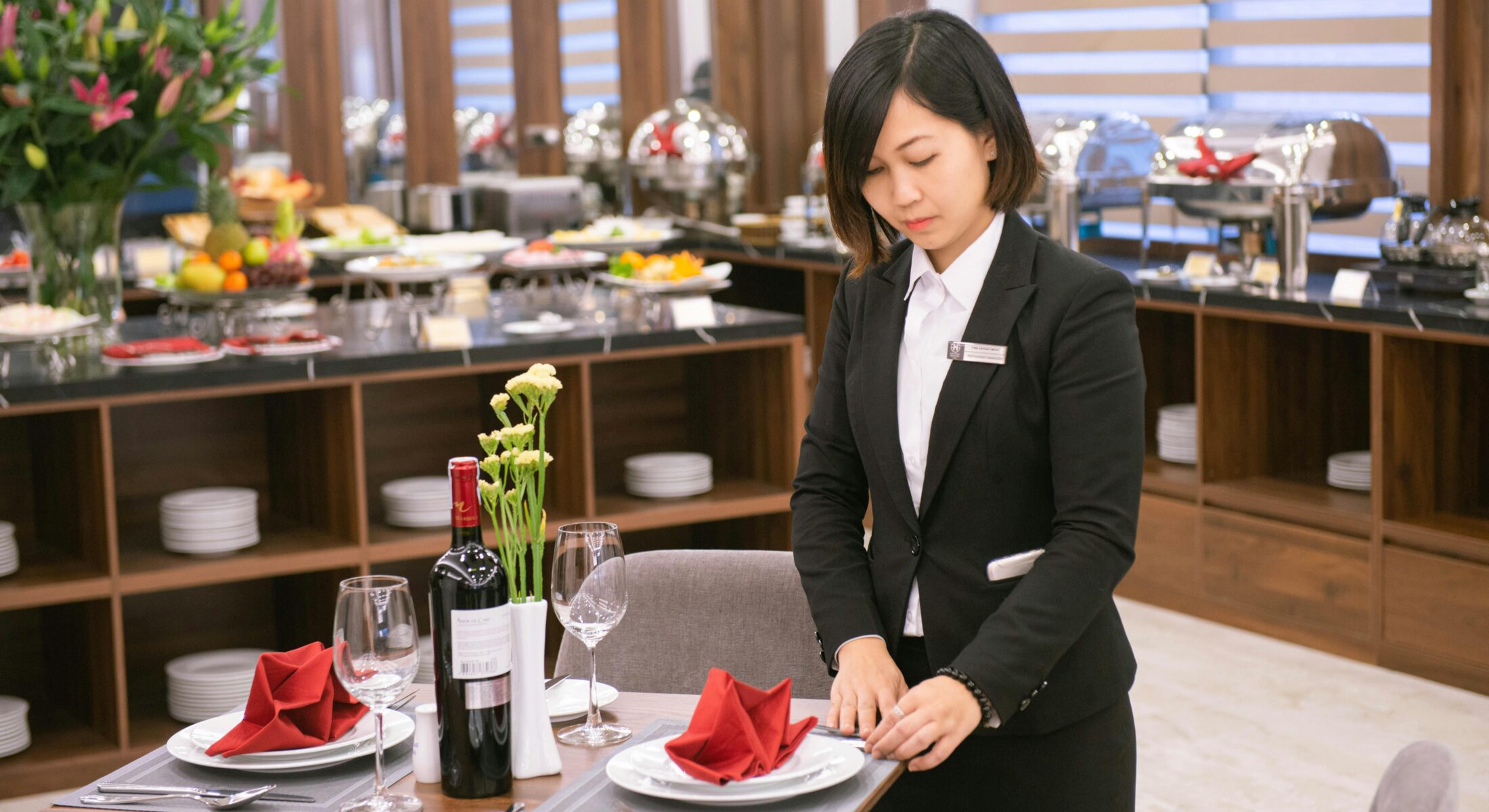 Hotel staff setting a dining table in a restaurant ahead of Food & Hospitality Asia 2026 in Singapore