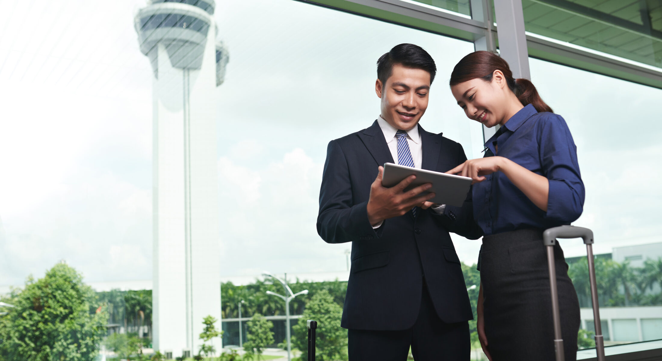 Business travellers reviewing travel plans at Singapore Changi Airport, preparing for conferences, exhibitions and corporate events in Singapore.