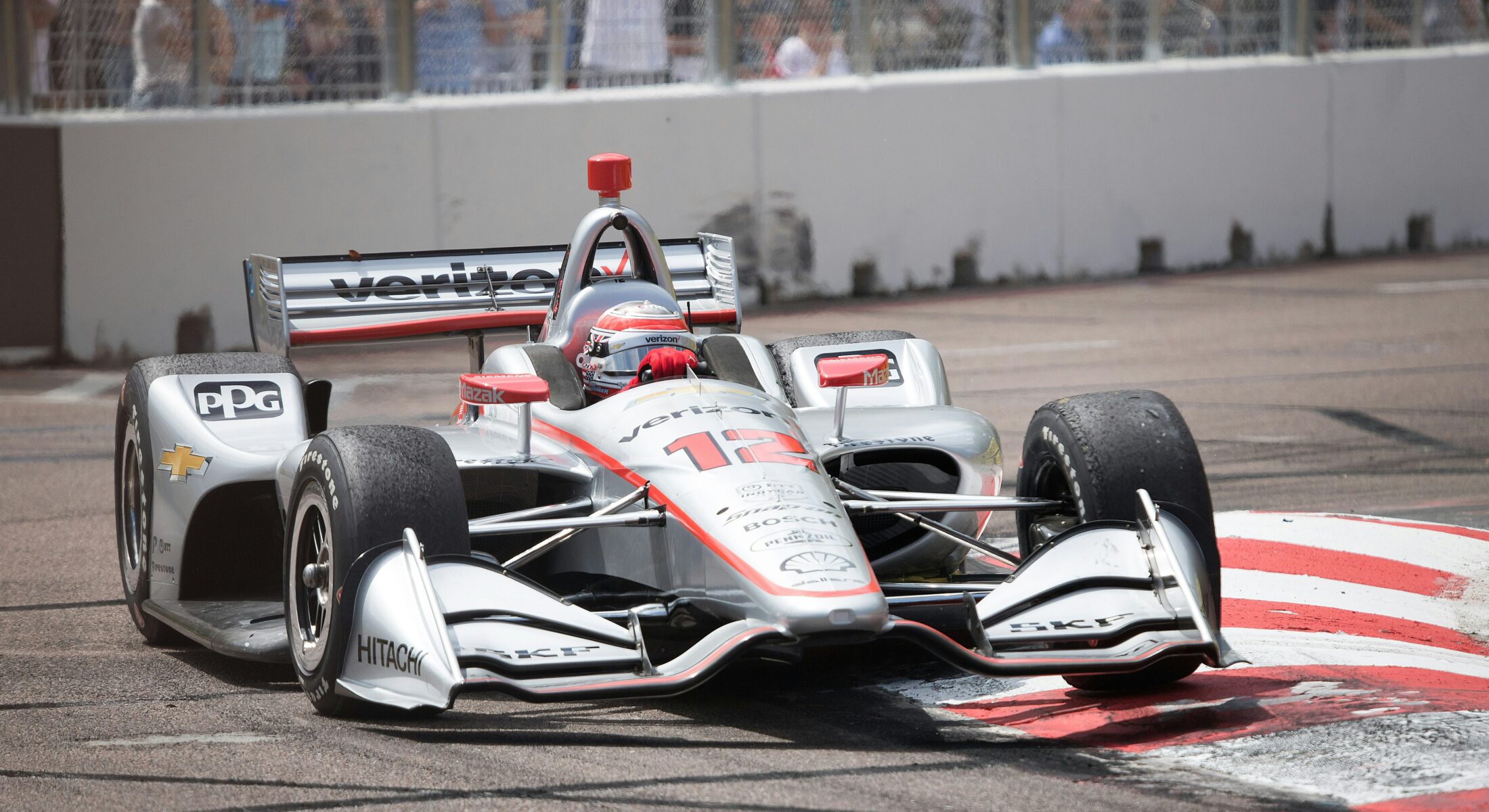 High-speed single-seater race car competing on a city street circuit during Singapore’s annual night race weekend at Marina Bay.