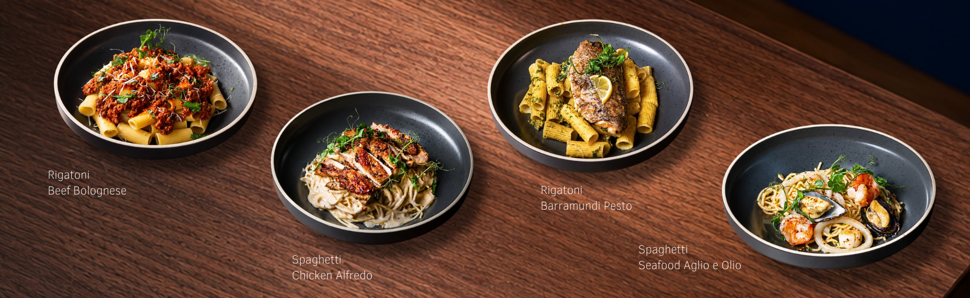 Four pasta dishes: beef bolognese rigatoni, chicken Alfredo spaghetti, barramundi pesto rigatoni and seafood aglio e olio.