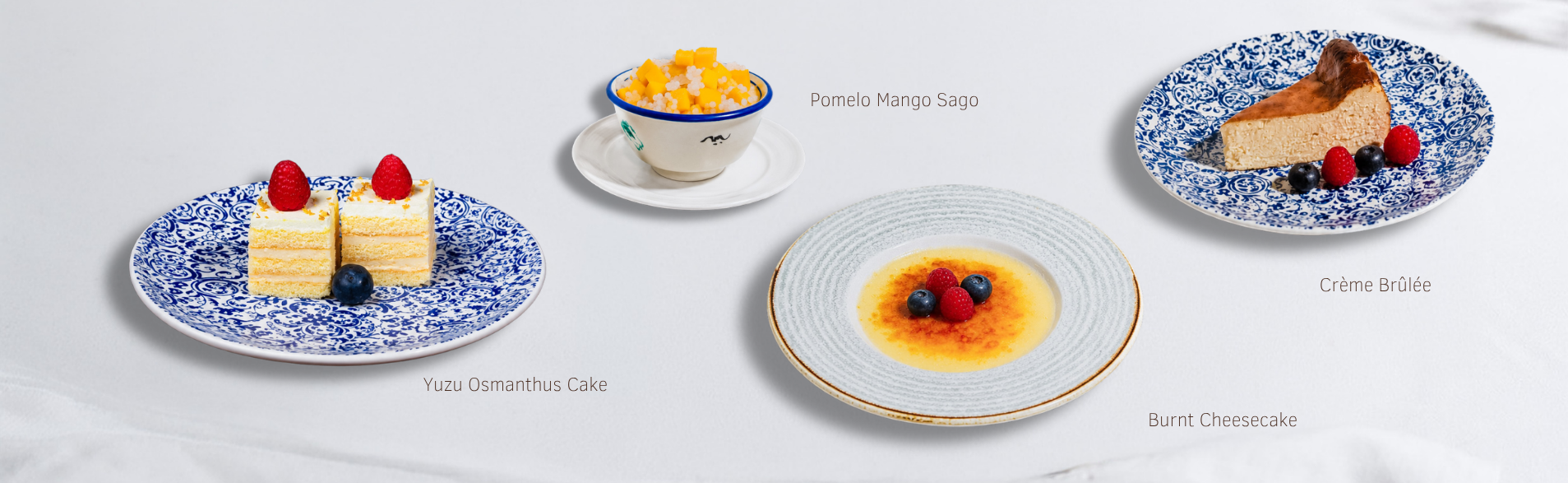 Yuzu osmanthus cake, pomelo mango sago, crème brûlée and burnt cheesecake on decorative plates.